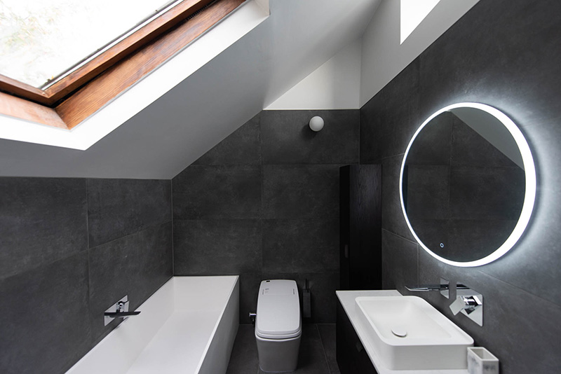 Modern renovated bathroom with grey slate tiles floor to ceiling